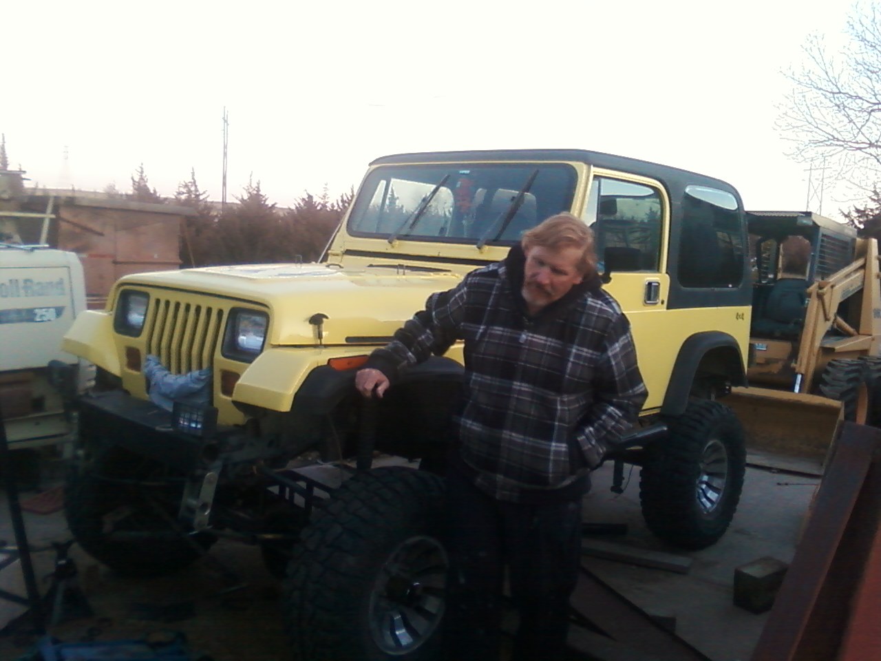 my pops standing next to my jeep he